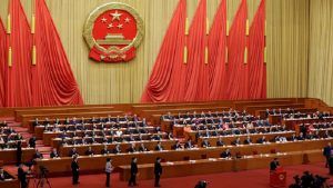 Delegates queue to drop their ballots during a vote at the fifth plenary session of the National People's Congress (NPC) at the Great Hall of the People in Beijing