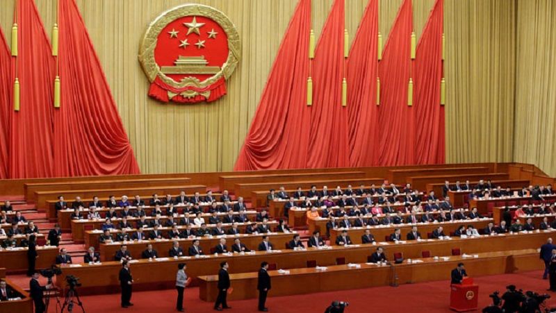 Delegates queue to drop their ballots during a vote at the fifth plenary session of the National People's Congress (NPC) at the Great Hall of the People in Beijing